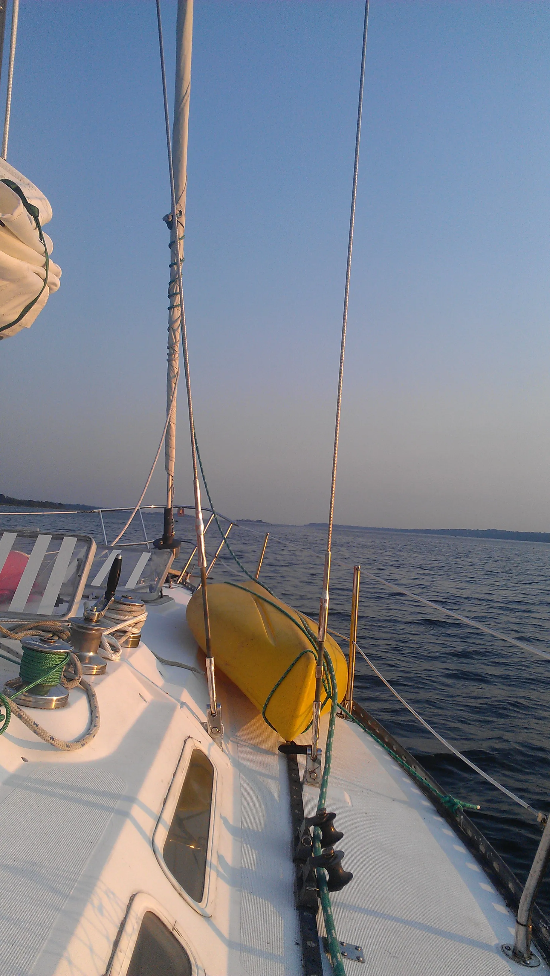 Ericson 37 sailboat in harbor, profile view of hull, cabin, and mast