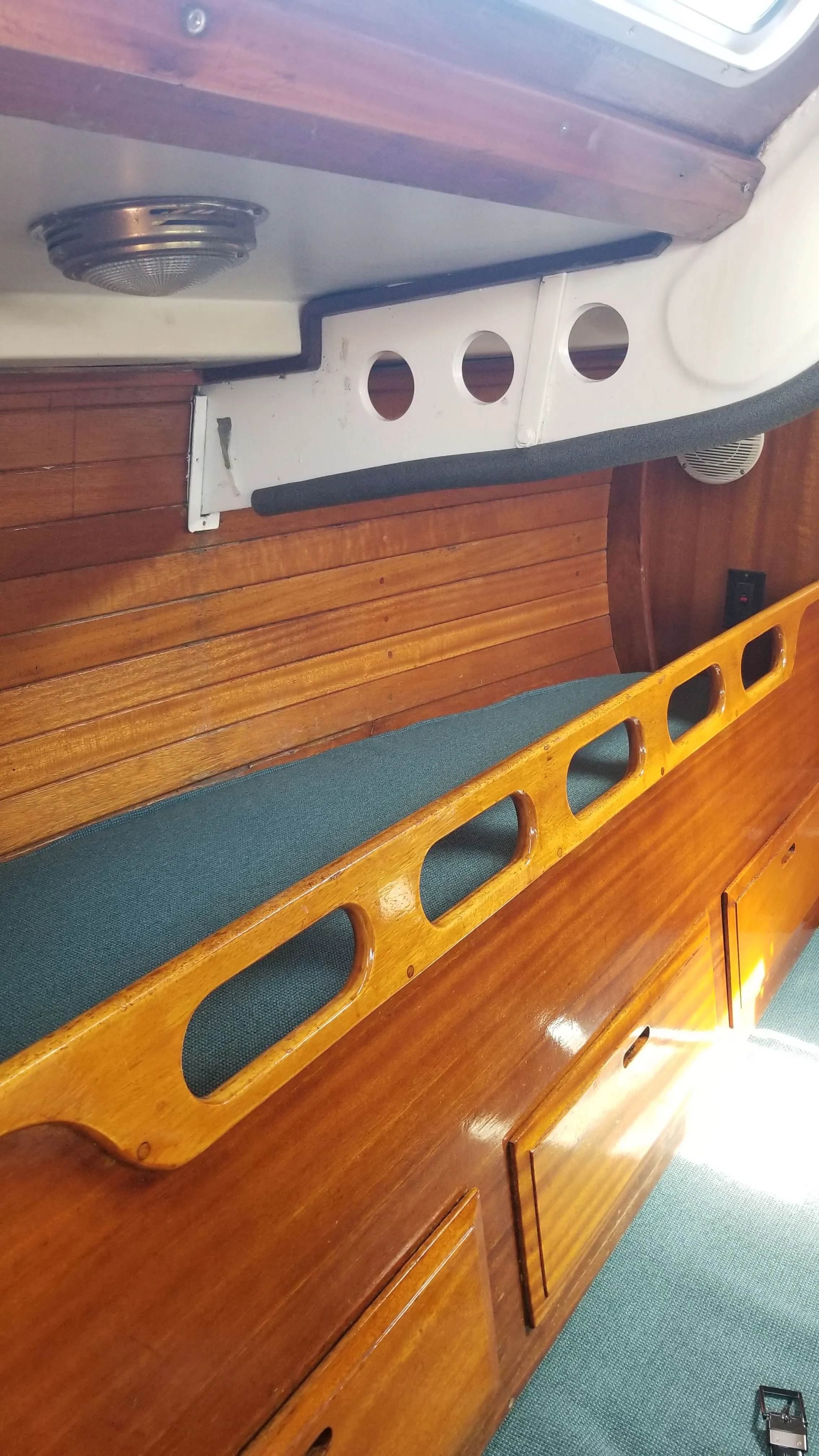 Forward V-berth with cushions and hull-side joinery