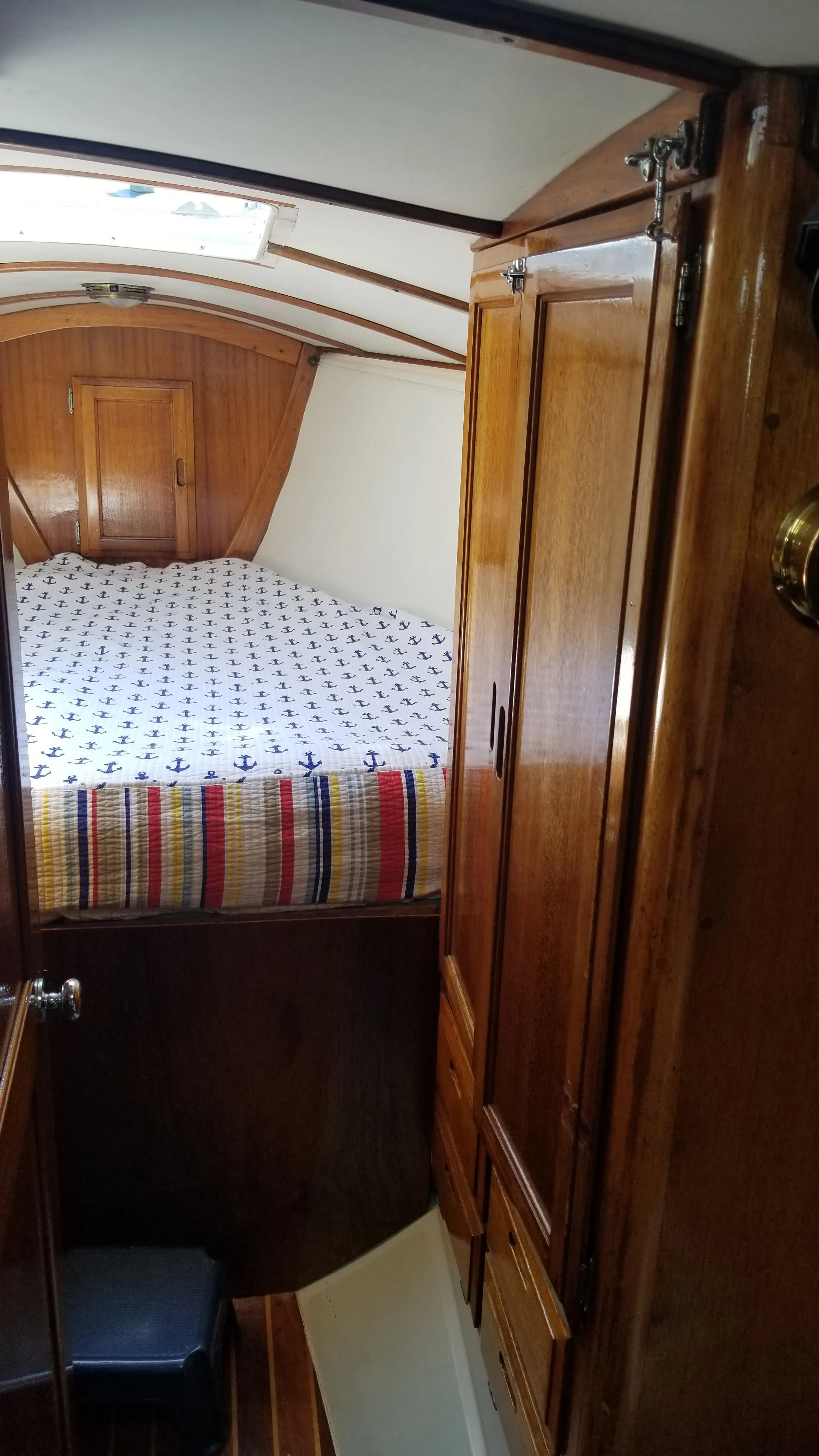 V-berth area with pillows and cabin lighting