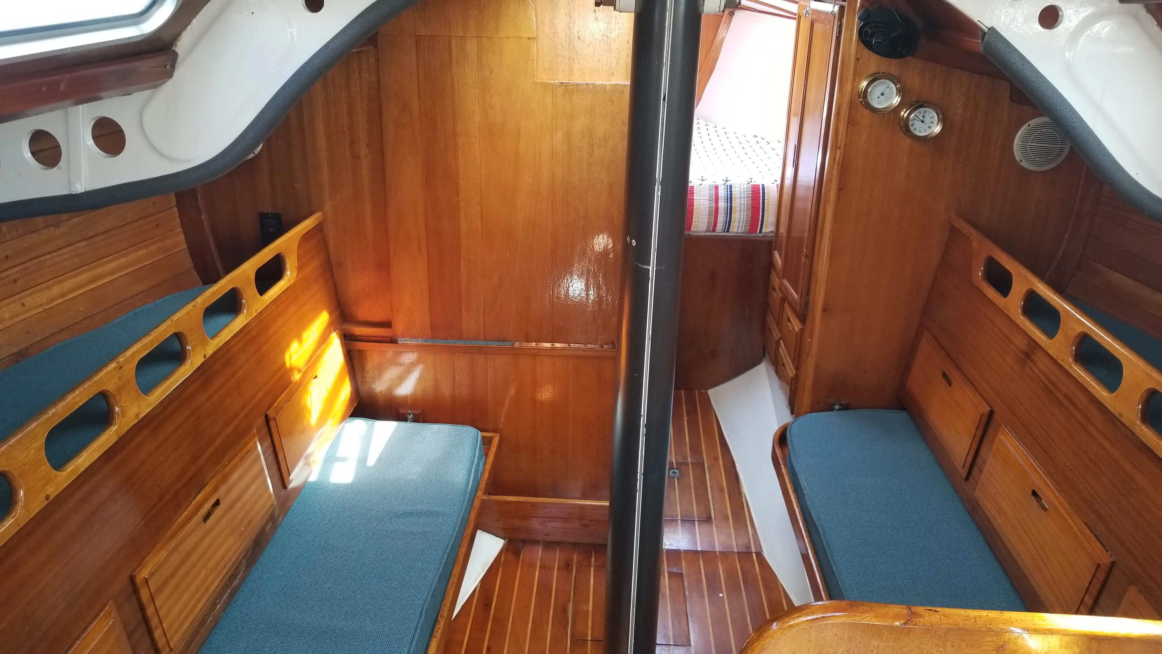 Nav corner with bulkhead-mounted instruments and berth nearby